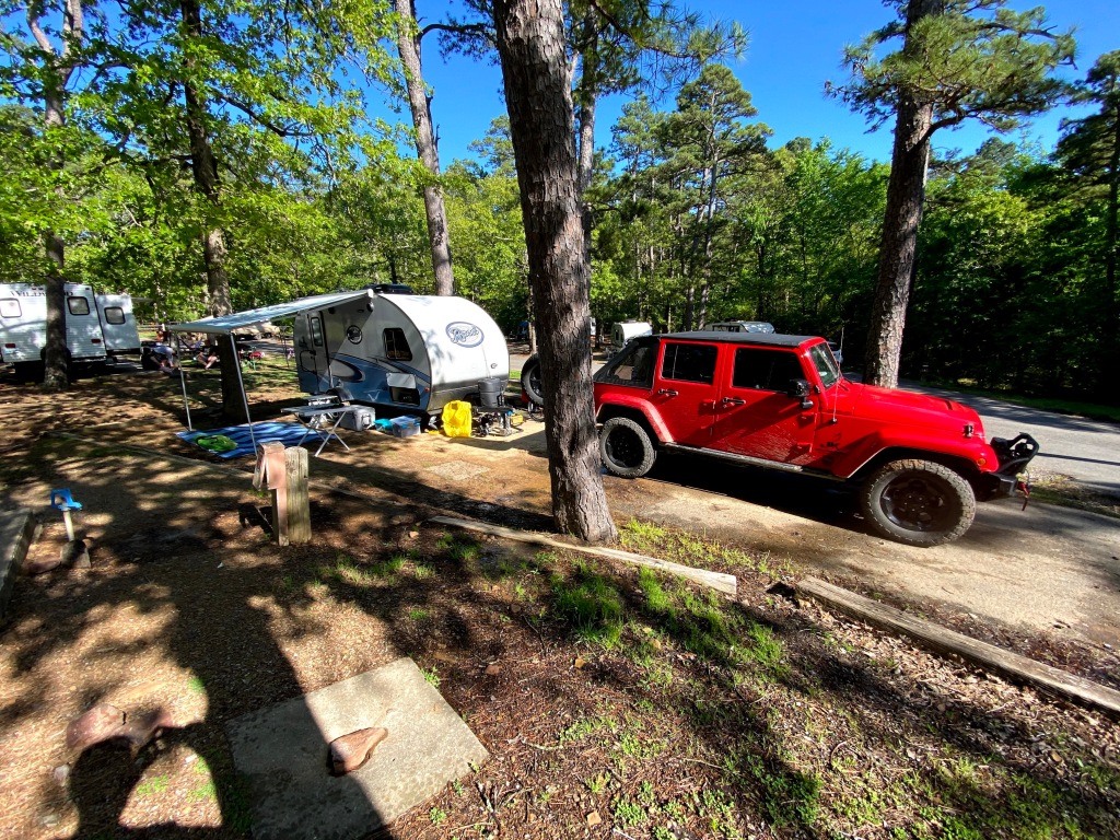 Jeep Wrangler and travel trailer camping site